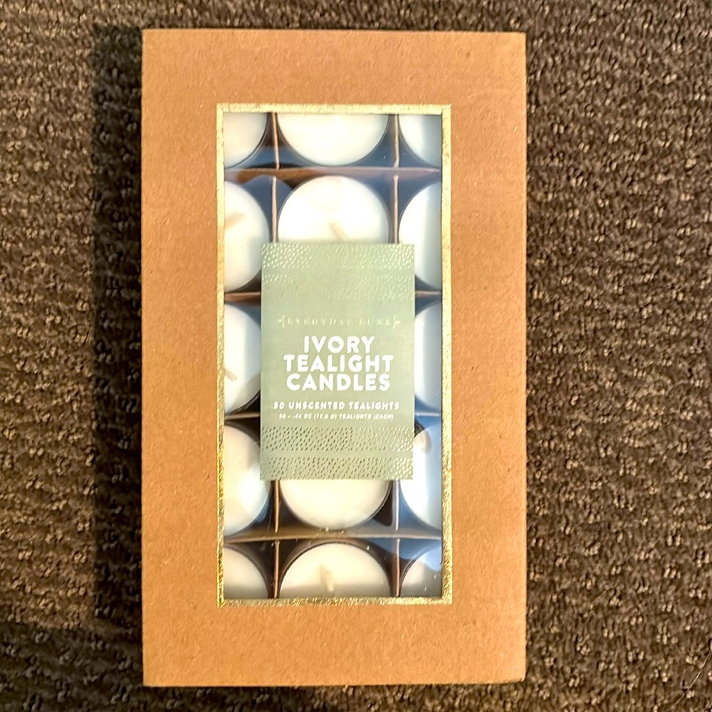 NWOT - box of 30 unscented ivory tealight candles. Box never opened.